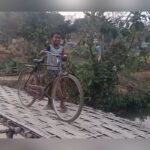 villagers in golaghati waiting for a concrete culvert