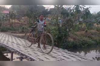 villagers in golaghati waiting for a concrete culvert